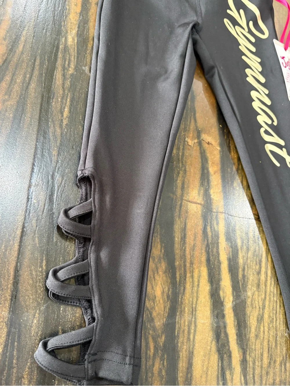 Justice Black Leggings with Pale Gold 'Gymnast' Script and Side Loop Detail